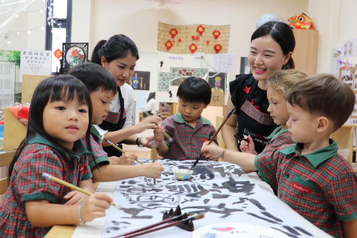 Teachers of EtonHouse International School guiding the students how to write
