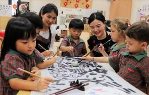 Teachers of EtonHouse International School guiding the students how to paint