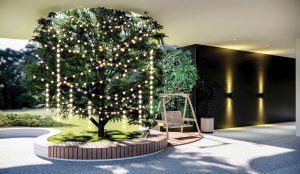 Indoor seating area with giant tree decorated with fairy lights