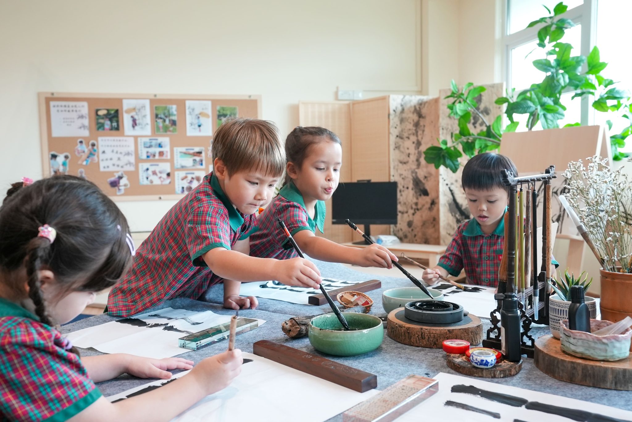 Students practicing calligraphy in a classroom