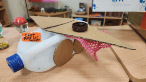 Arts and craft plane with cardboard wings and bottle body