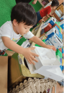 Student grabbing a box for his art project