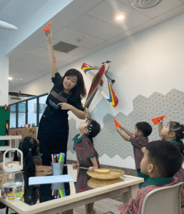 Teacher engaging students about flight using a triangle
