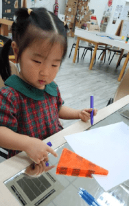 Student learning how to draw a triangle