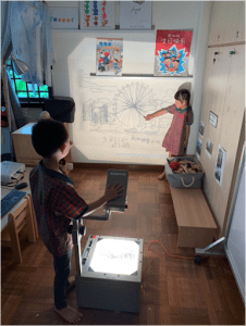 Student pointing out the Singapore flyer shown on a projector