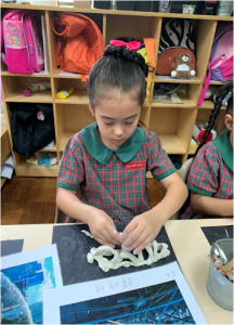 Student using clay for her art project