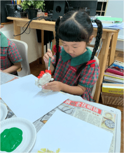 Student painting her art piece