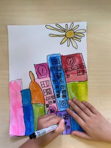 A colourful drawing of different shaped buildings