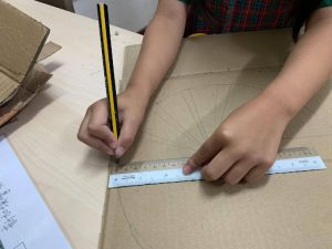Student drawing the outline of a ferris wheel
