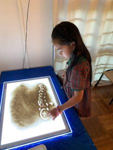 Student using a large etech a sketch to draw