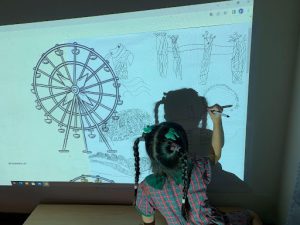 Student drawing the Singapore Flyer on the whiteboard