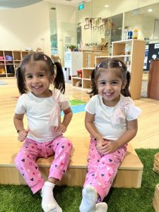 Two smiling girls sporting pigtails