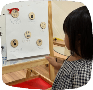 Child learning about different emotions in a matching exercise
